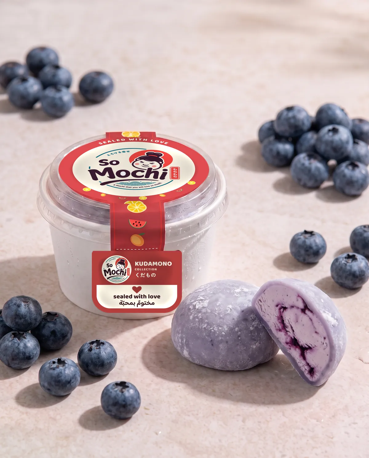Jumbo Blueberry mochi, whole and cut open, beside its sealed So Mochi cup