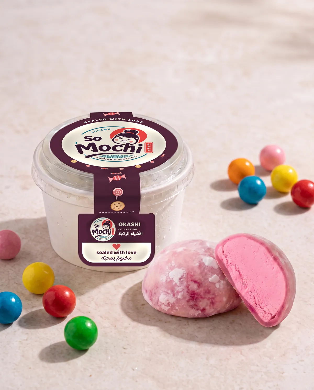 Jumbo Bubblegum mochi, whole and cut open, beside its sealed So Mochi cup
