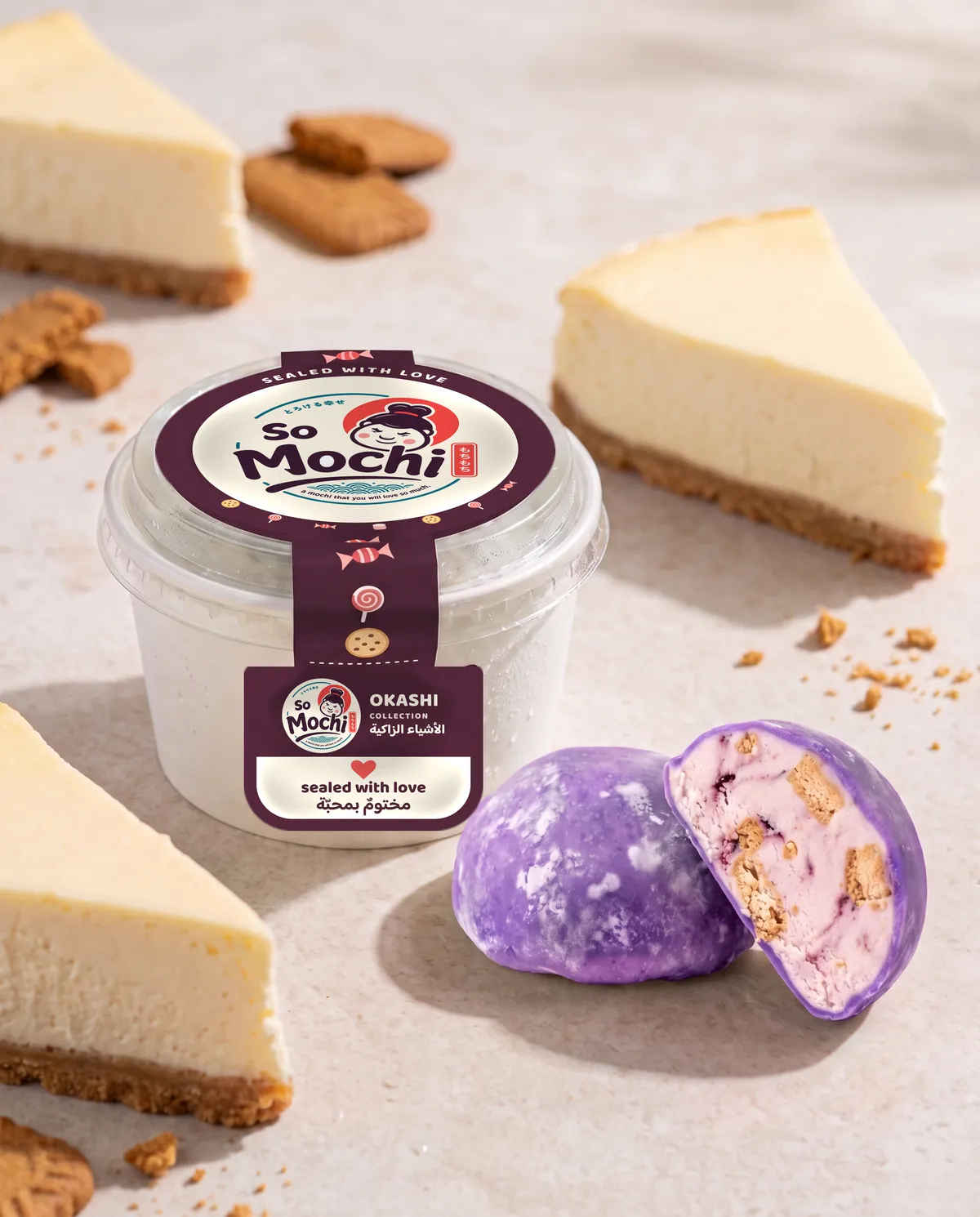 Jumbo Cheesecake mochi, whole and cut open, beside its sealed So Mochi cup
