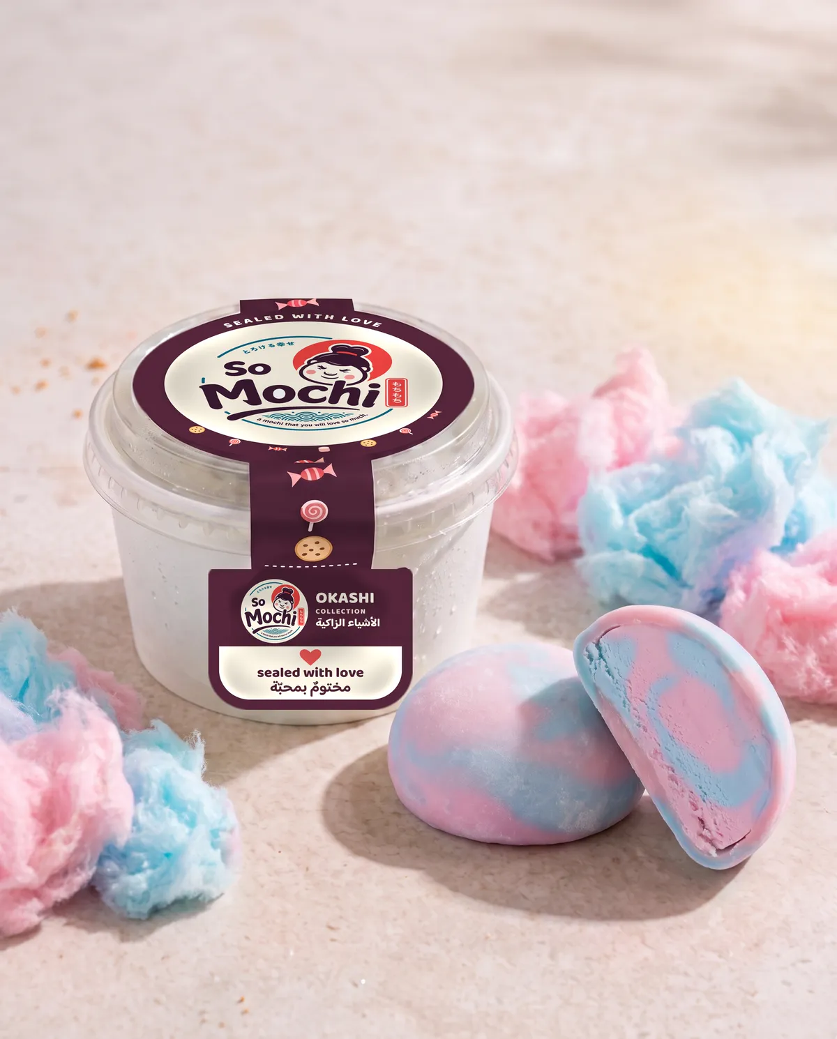 Jumbo Cotton Candy mochi, whole and cut open, beside its sealed So Mochi cup