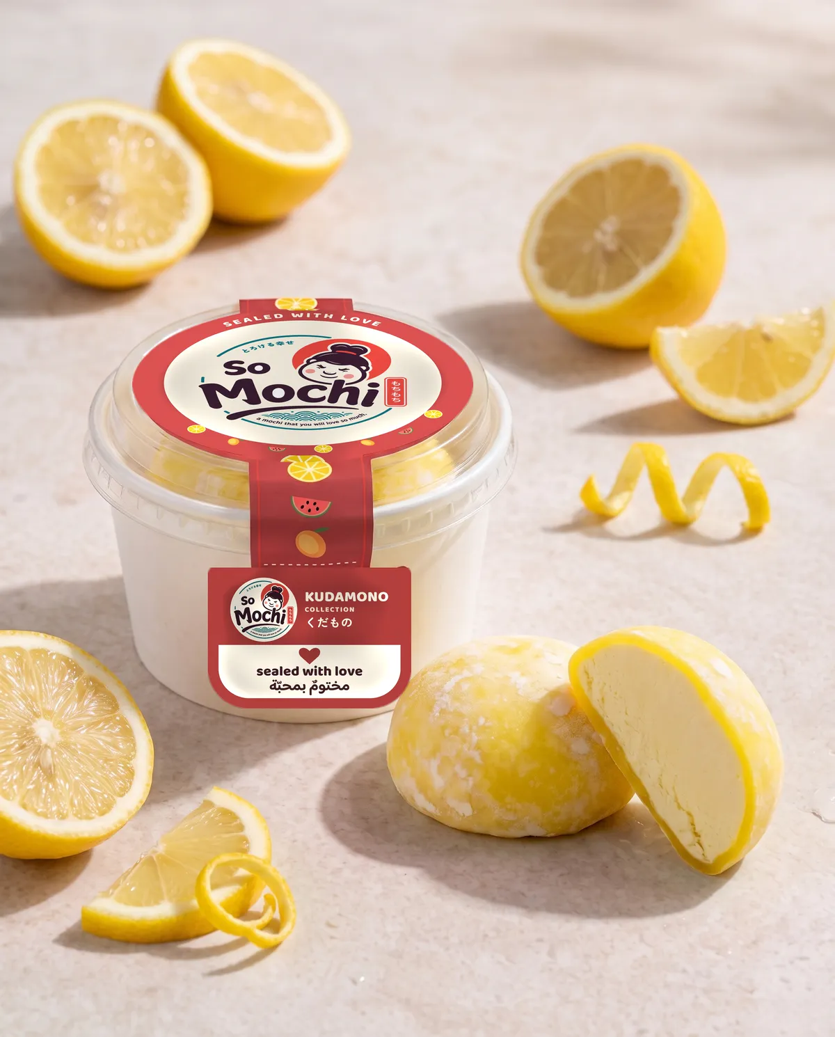 Jumbo Lemon mochi, whole and cut open, beside its sealed So Mochi cup