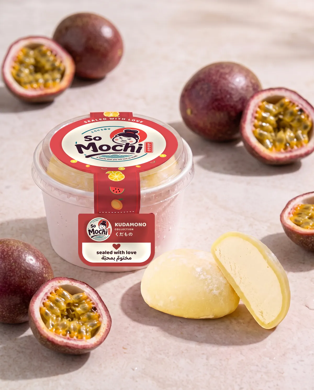 Jumbo Passion Fruit mochi, whole and cut open, beside its sealed So Mochi cup