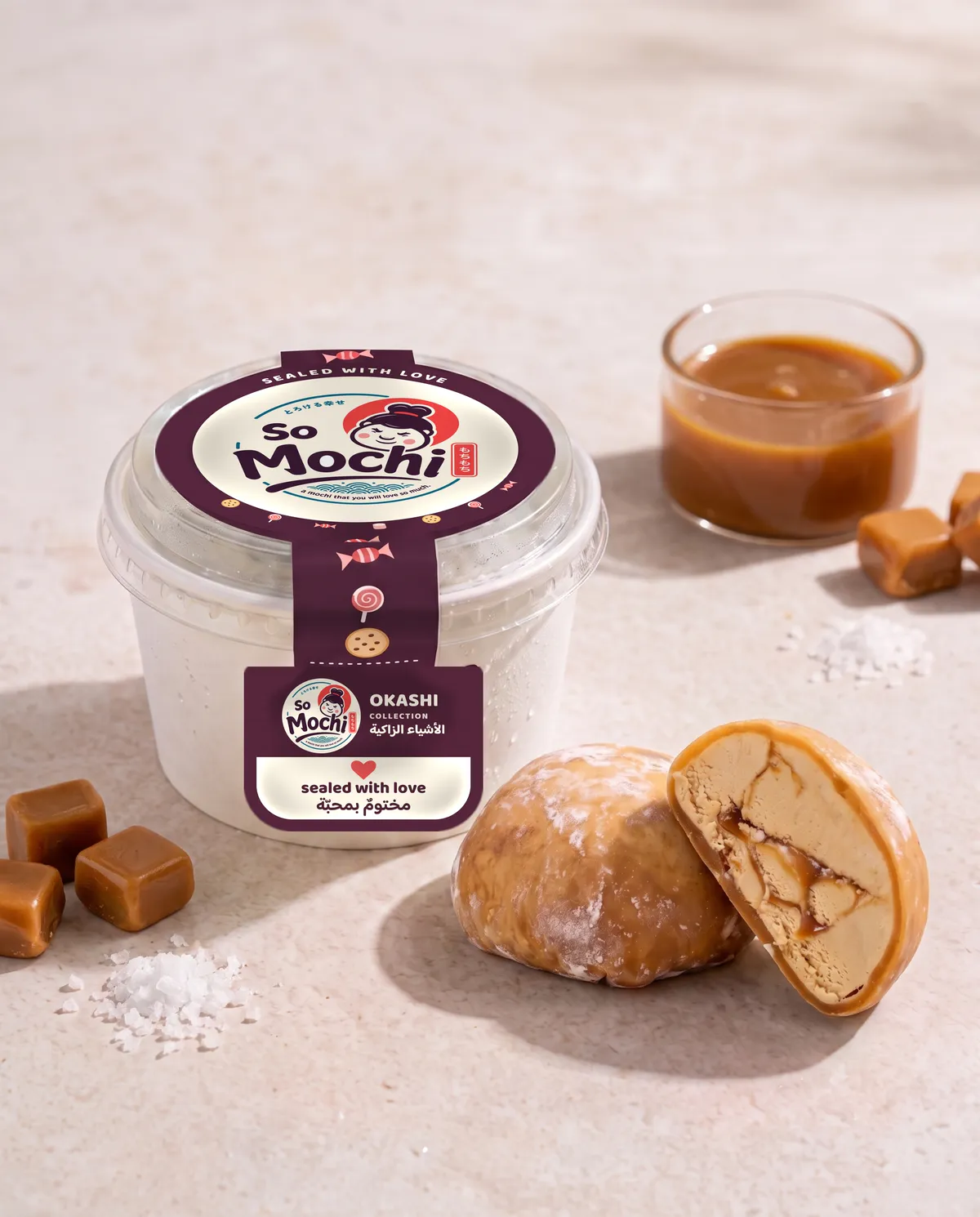 Jumbo Salted Caramel mochi, whole and cut open, beside its sealed So Mochi cup