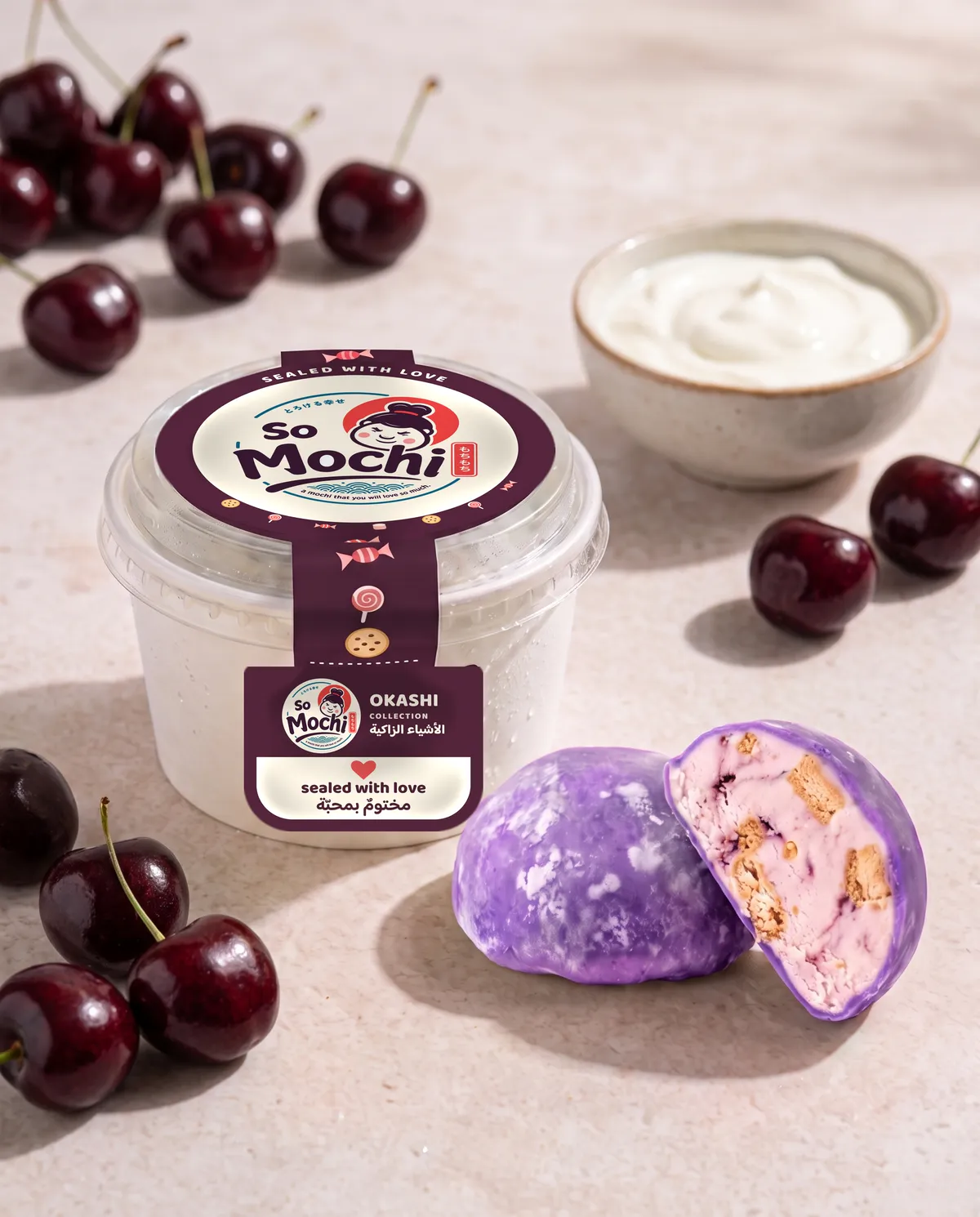 Jumbo Yogurt & Cherry mochi, whole and cut open, beside its sealed So Mochi cup